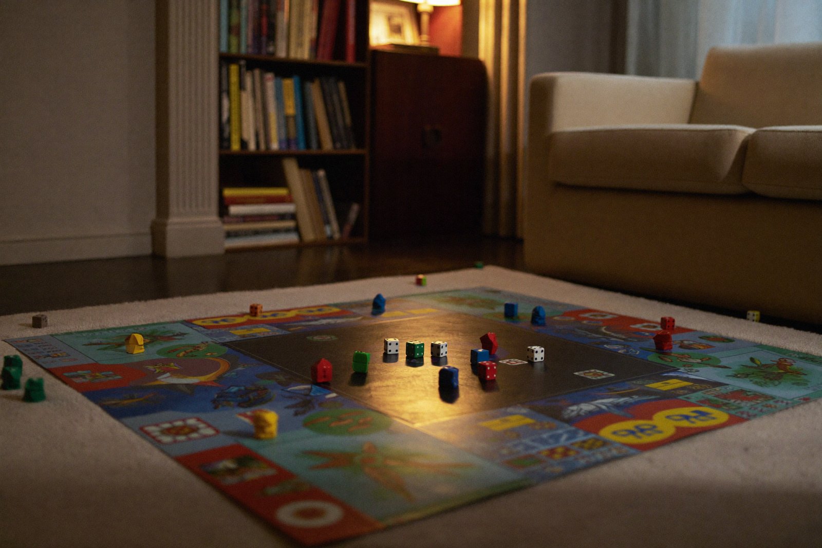 Kids playing a board game on a living room floor, no screens in sight, warm evening light